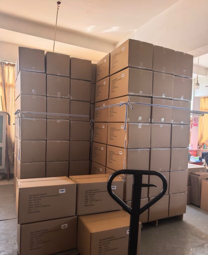 a warehouse filled with stacked boxes of straw hats ready for shipment. The neatly packed boxes suggest organized inventory awaiting dispatch.