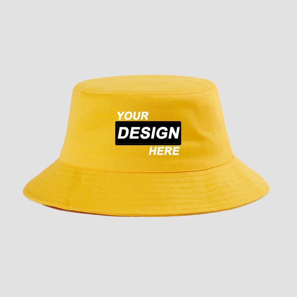 Yellow custom bucket hat mockup with front logo patch reading “YOUR DESIGN HERE”.