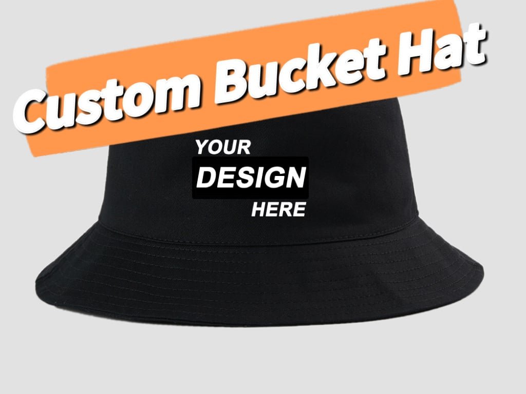 Custom bucket hat cover image showing a black bucket hat with “YOUR DESIGN HERE” on the front and an orange banner reading “Custom Bucket Hat”.