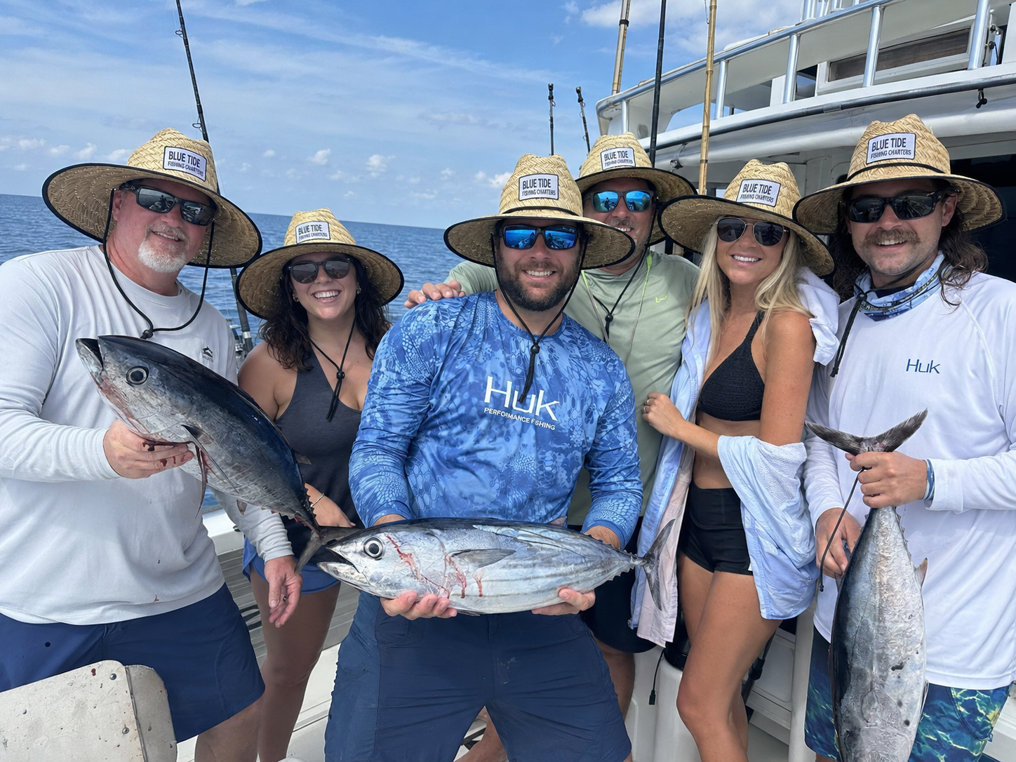 Fishing charter crew and guests wearing custom logo straw hats